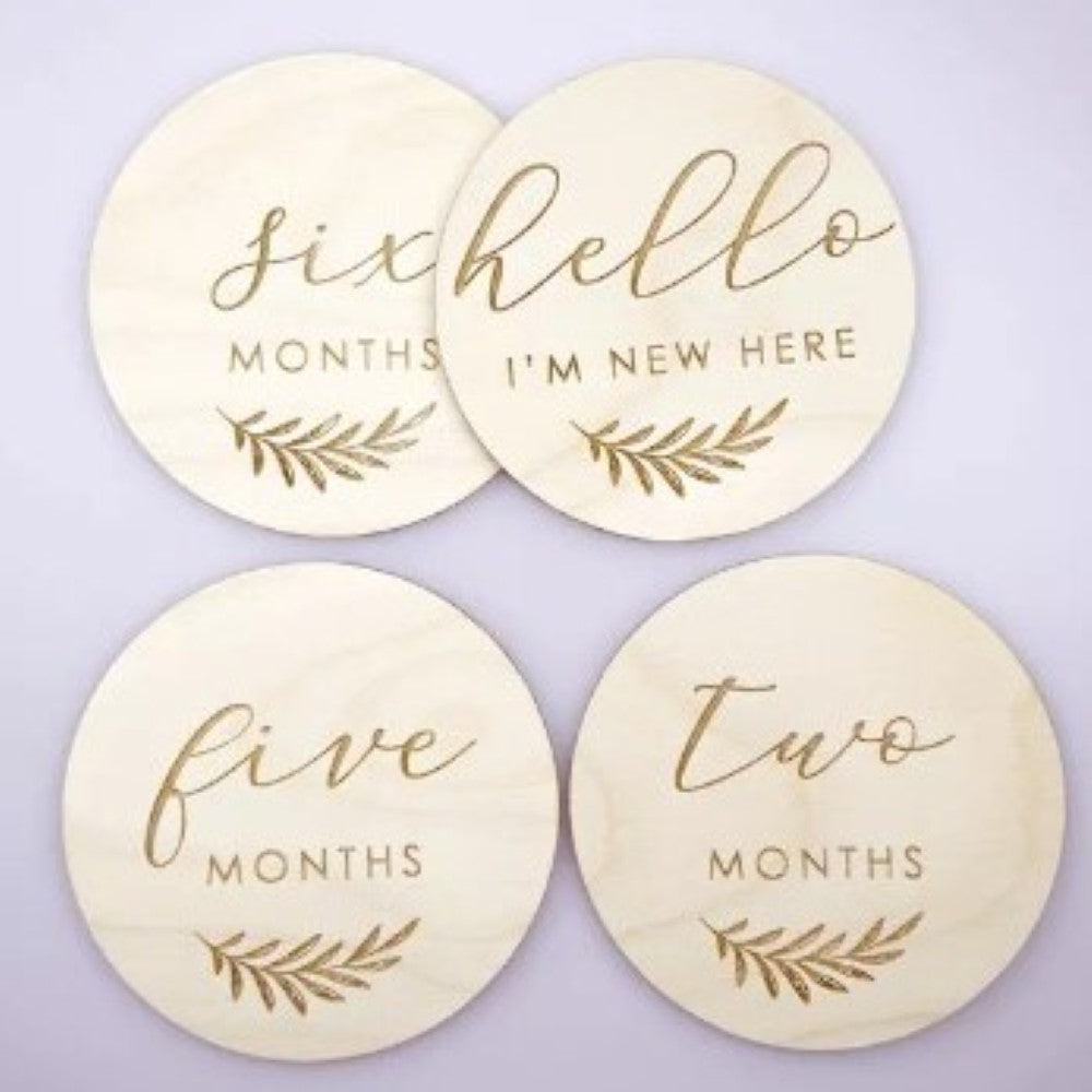 Baby's wooden milestone cards in english.